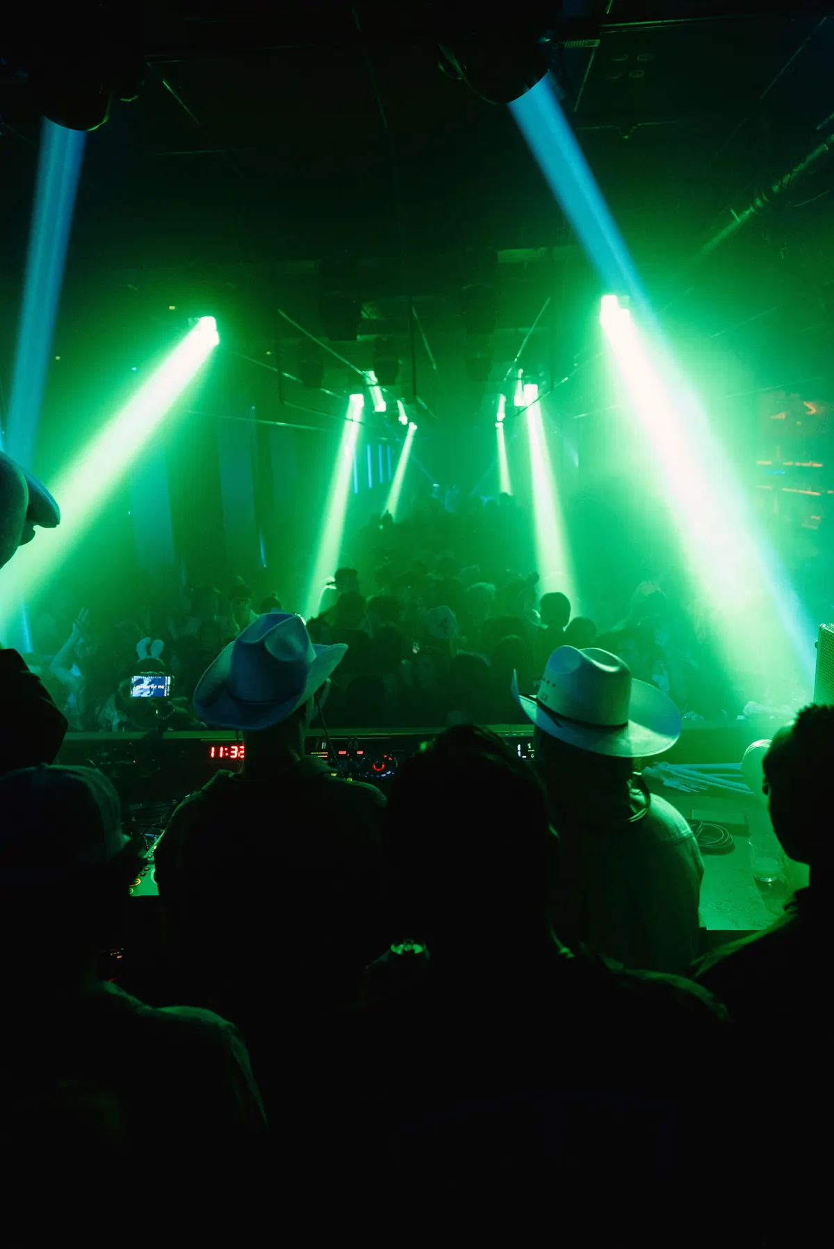 Green laser beams over a packed dance floor at a Toronto house music night