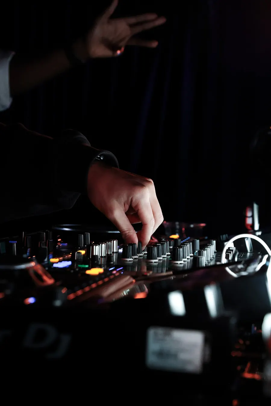 Close-up of a DJ's hand on the mixer
